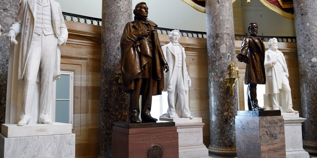 FILE - In this June 24, 2015 file photo, a statue of Jefferson Davis, second from left, president of the Confederate States from 1861 to 1865, is on display in Statuary Hall on Capitol Hill in Washington. The House voted July 22, 2020, to remove statues of Confederate figures such as Jefferson Davis from the U.S. Capitol. (AP Photo/Susan Walsh, File)