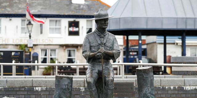 A statue of the founder of the Scout movement Robert Baden-Powell on Poole Quay in Dorset, England ahead of its expected removal to "safe storage" following pressure to remove it over concerns about his alleged actions while in the military and "Nazi sympathies" Thursday June 11, 2020. (Andrew Matthews/PA via AP)