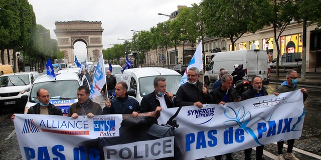 French police unionists demonstrate with a banner reading "No police, no peace" on the Champs-Elysee avenue near the Arc de Triomphe on Friday in Paris. French police are protesting a new ban on chokeholds and limits to what they can do during arrests, part of government efforts to stem police brutality and racism in the wake of global protests over George Floyd's death in the U.S. (AP Photo/Michel Euler) 