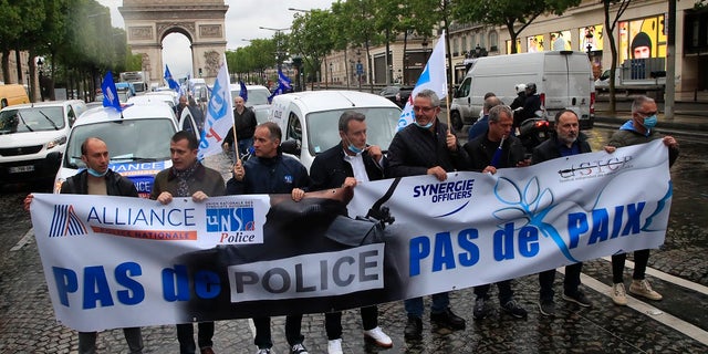 French police unionists demonstrate with a banner reading
