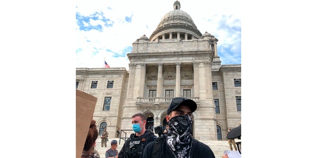 Protesters attend a rally outside the statehouse in Providence, R.I., on June 5, 2020. The smallest U.S. state has the longest name, and it's not sitting well for some in the George Floyd era. Officially, Rhode Island was incorporated as 