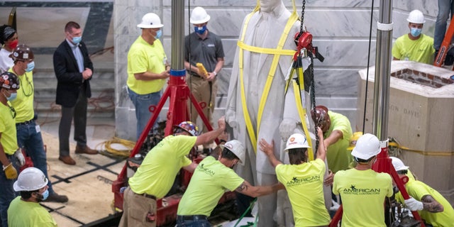 Workers prepare to remove the Jefferson Davis statue from the Kentucky state Capitol in Frankfort, Ky., on June 13. (Ryan C. Hermens/Lexington Herald-Leader via AP)