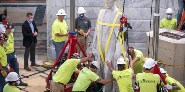 Workers prepare to remove the Jefferson Davis statue from the Kentucky state Capitol in Frankfort, Ky., on June 13. (Ryan C. Hermens/Lexington Herald-Leader via AP)