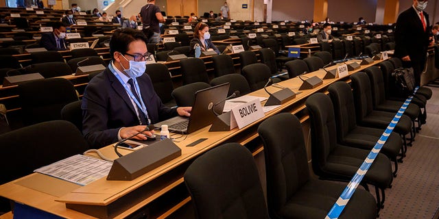 Delegates wearing protective face masks attend the resuming of the UN Human Rights Council session after the break-in March over the coronavirus pandemic, on Monday, 15 June 2020, in Geneva.