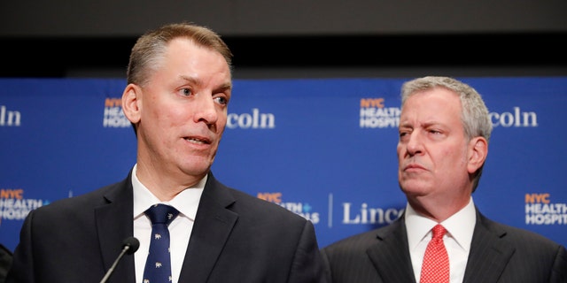 New York City Police Commissioner Dermot Shea, left, speaks alongside Mayor Bill de Blasio during a news conference in New York in an undated photo. (AP Photo/John Minchillo, File)