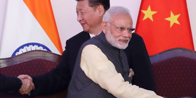 In this Oct. 16, 2016, file photo, Indian Prime Minister Narendra Modi, front and Chinese President Xi Jinping shake hands with leaders at the BRICS summit in Goa, India. (AP Photo/Manish Swarup, File)