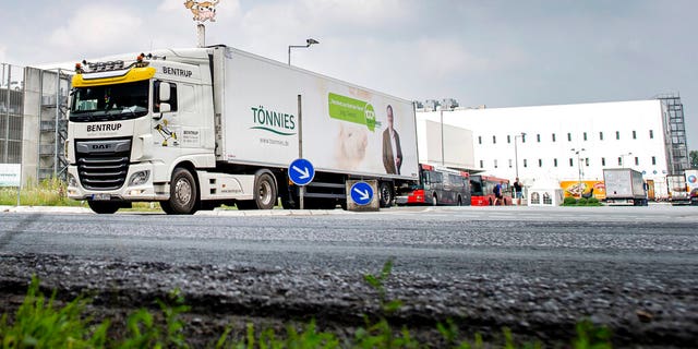 A truck leaves the Toennies meatpacking plant in Rheda-Wiedenbrueck, Germany, where more than 650 new cases of COVID-19 have been recorded among workers at a large meatpacking plant.
