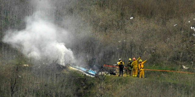 <br>
Firefighters work the scene of a helicopter crash where former NBA star Kobe Bryant died in Calabasas, Calif., Jan. 26, 2020. (Associated Press)