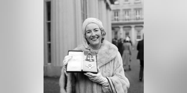 Singer Vera Lynn poses outside Buckingham Palace after being invested a Dame Commander of the British Empire on Dec. 2, 1975. The family of World War II forces sweetheart Vera Lynn says she has died. Her passing was reported on Thursday, June 18, 2020. She was 103. (PA via AP, File)