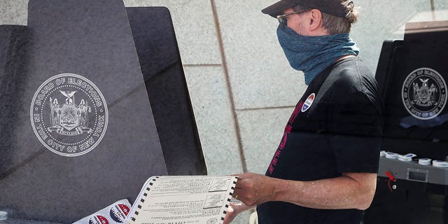 FILE - In this June 16, 2020, file photo, a voter casts their ballot at a polling station inside the Brooklyn Museum as early voting continues in the Brooklyn borough of New York. (AP Photo/John Minchillo, File)