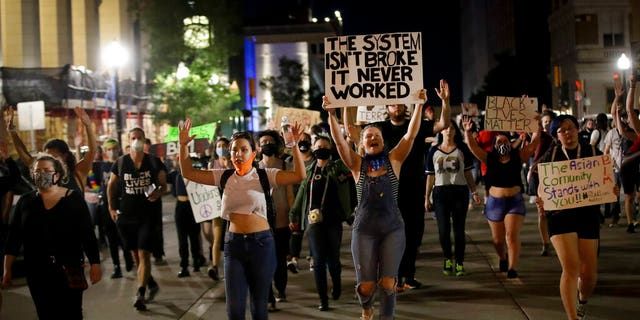 Demonstrators march near the BOK Center where President Trump is holding a campaign rally in Tulsa, Okla., Saturday, June 20, 2020. (AP Photo/Charlie Riedel)