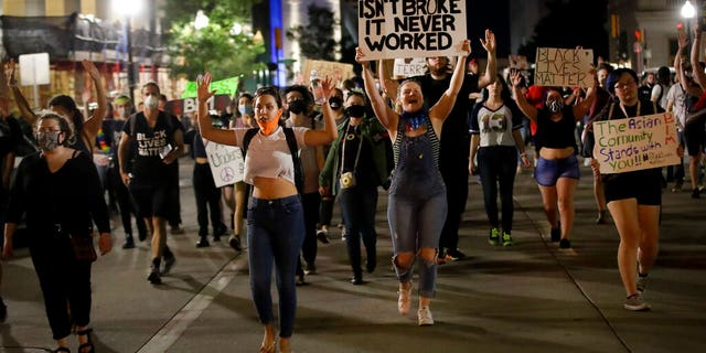 Demonstrators march near the BOK Center where President Trump is holding a campaign rally in Tulsa, Okla., Saturday, June 20, 2020. (AP Photo/Charlie Riedel)