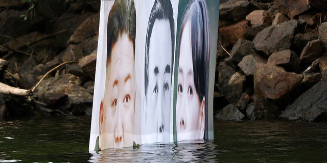 A banner with images of North Korean leader Kim Jong Un, left, the late leader Kim Il Sung, center, and Kim Yo Jong, the powerful sister of Kim Jong Un, released by Fighters For Free North Korea, is seen in Hongcheon, South Korea, Tuesday, June 23, 2020. (Yang Ji-woong/Yonhap via AP)