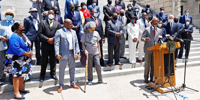 Lawmakers and members of the Mississippi Legislative Black Caucus call on the Legislature to vote for a new flag this session, during a news conference in front of the Capitol in Jackson, Miss.