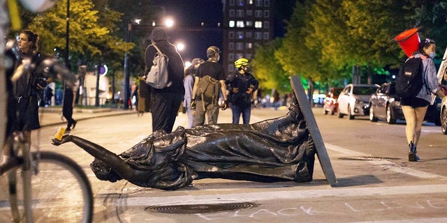 Wisconsin's "Forward" statue lies in the street on Capitol Square in Madison on Tuesday. The statue has since been recovered, officials said. (Emily Hamer/Wisconsin State Journal via AP)