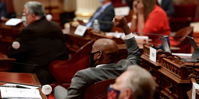 California state Sen. Steven Bradford, D-Gardena, center, raises his fist in celebration after lawmakers agree to place a proposed Constitutional amendment on the November ballot to overturn the state's ban on affirmative action programs, at the Capitol, in Sacramento, June 24, 2020. (Associated Press)