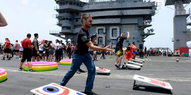 In this June 6, 2020, photo provided by the U.S. Navy, sailors participate in sporting events on the flight deck of the aircraft carrier USS Dwight D. Eisenhower (CVN 69). (Mass Communication Specialist Seaman Brennen Easter/U.S. Navy via AP)