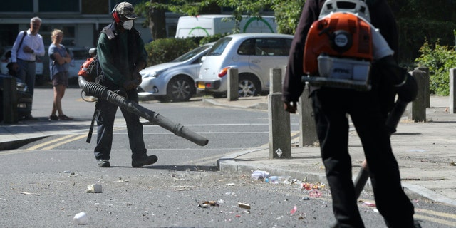 Volunteers clean up in Overton Road, Angell Town, Brixton, south London, where riots and violent confrontations with police took place overnight. Fifteen officers were injured and four people were arrested following the incident. PA Photo. Picture date: Thursday June 25, 2020. See PA story POLICE Brixton. Photo credit should read: Jonathan Brady/PA Wire