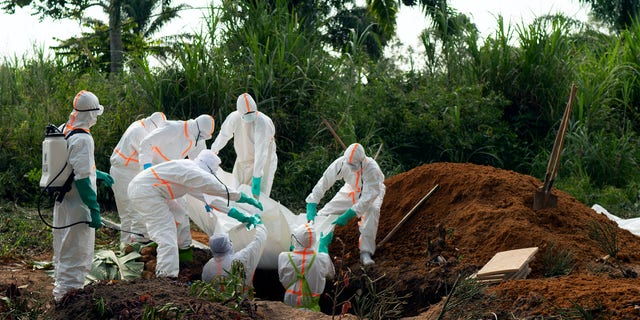 FILE - In this Sunday, July 14, 2019 file photo, an Ebola victim is put to rest at the Muslim cemetery in Beni, Congo. Eastern Congo on Thursday, June 25, 2020 has marked an official end to the second-deadliest Ebola outbreak in history that killed 2,280 people over nearly two years as armed groups and community mistrust undermined the promise of new vaccines. (AP Photo/Jerome Delay, File)