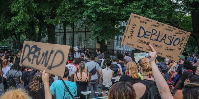 Protestors supporting City Workers4Justice—an activist organization for city employees, rally outside City Hall Thursday, June 25, 2020, in New York, and call on Mayor Bill de Blasio to defund the NYPD. (AP Photo/Bebeto Matthews)