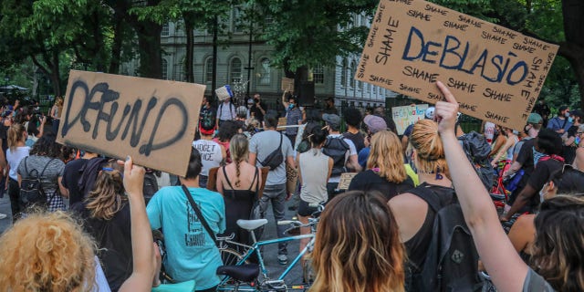 Protestors supporting City Workers4Justice—an activist organization for city employees, rally outside City Hall Thursday, June 25, 2020, in New York, and call on Mayor Bill de Blasio to defund the NYPD. (AP Photo/Bebeto Matthews)