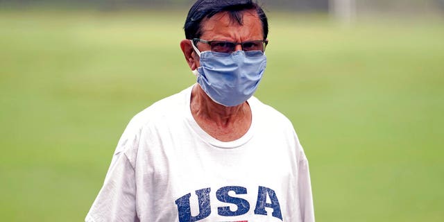 Shiraz Merchant wears a mask as he walks in a park Friday, June 26, 2020, in Houston. The number of COVID-19 cases continues to rise across the state. Texas Gov. Greg Abbott has said that the state is facing a "massive outbreak" in the coronavirus pandemic and that some new local restrictions may be needed to protect hospital space for new patients. (AP Photo/David J. Phillip)