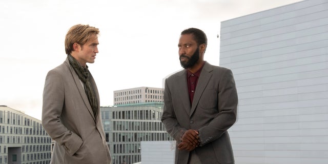 Robert Pattinson, left, and John David Washington in a scene from "Tenet." Tom Cruise shared a video of his theatergoing experience on Twitter. (Associated Press)