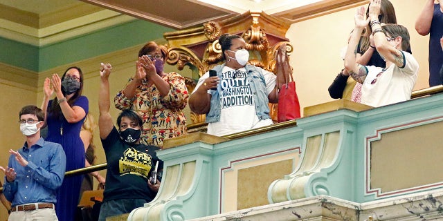 Members of the Mississippi Senate gallery rise and applaud after the body passed a resolution that would suspend the rules to allow lawmakers to change the state flag, Saturday, June 27, 2020 at the Capitol in Jackson, Miss. (Associated Press)