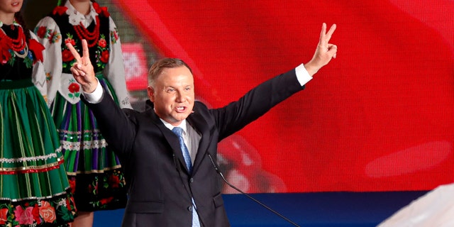 President Andrzej Duda flashing victory signs after voting ended in Lowicz, Poland, on Sunday.