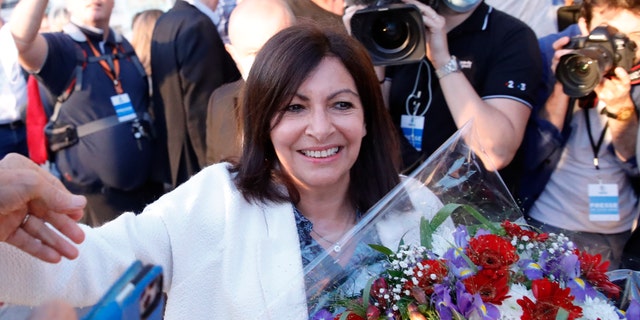 Paris Mayor Anne Hidalgo getting a bouquet of flowers after her victorious second round of the municipal election Sunday.