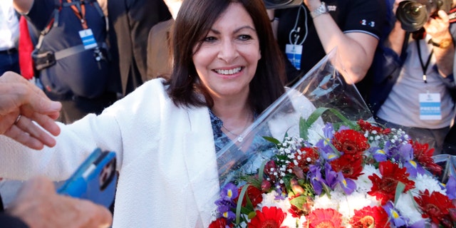 Paris Mayor Anne Hidalgo getting a bouquet of flowers after her victorious second round of the municipal election Sunday.