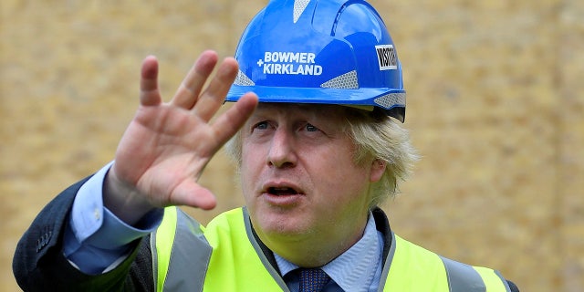 Britain's Prime Minister Boris Johnson visits the construction site of Ealing Fields High School in west London on Monday, June 29, 2020. (Toby Melville/Pool via AP)