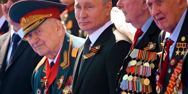 FILE: Russian President Vladimir Putin, center, watches the Victory Day military parade marking the 75th anniversary of the Nazi defeat in Moscow.