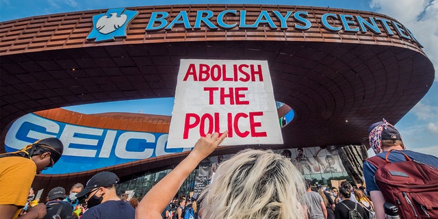 BROOKLYN, NEW YORK, UNITED STATES - 2020/05/29: A participant holding a sign reading Abolish The Police at the protest outside the Barclays Center. Hundreds of protesters made their way toward Barclays Center in Brooklyn to demonstrate against police brutality in the wake of George Floyd's death while in police custody in Minneapolis. (Photo by Erik McGregor/LightRocket via Getty Images)