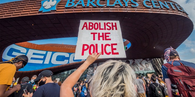 A participant holding a sign reading "Abolish The Police" at the protest outside the Barclays Center. (Photo by Erik McGregor/LightRocket via Getty Images)