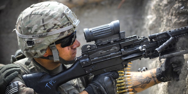 A US soldier from 2-12 Infantry Regiment out of Colorado Springs fires a machine gun at insurgent positions during a firefight on June 22, 2012 in the Pech Valley, Afghanistan - file photo.