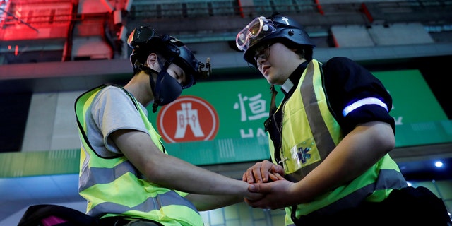 Pastor Alan Keung prays with a first aid volunteer who asked Alan to do so during an anti-government protest in Hong Kong, China, November 2019. (REUTERS/Kim Kyung-Hoon)