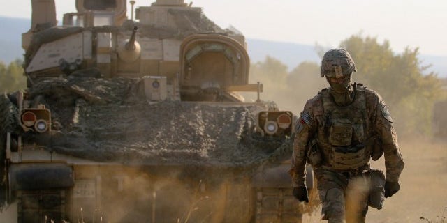 U.S. Army Sgt. 1st Class Chez Carter, assigned to Alpha Company, 2nd Battalion, 5th Cavalry Regiment, 1st Armored Brigade Combat Team, 1st Cavalry Division ground guides a M2A3 Bradley Fighting Vehicle during a Table XII Live Fire Exercise, Novo Selo.