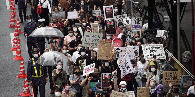 People march to protest during a solidarity rally for the death of George Floyd in Tokyo Sunday, June 14, 2020. Holding handmade signs that read “Black Lives Matter,” several hundred people marched peacefully at a Tokyo park Sunday, highlighting the outrage over the death of Floyd even in a country often perceived as homogeneous and untouched by racial issues. (AP Photo/Eugene Hoshiko)