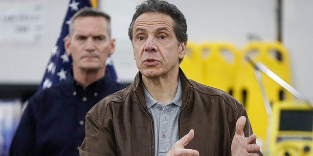 New York Gov. Andrew Cuomo speaks during a news conference alongside the National Guard at the Jacob Javits Center that will house a temporary hospital in response to the COVID-19 outbreak in March. (AP Photo/John Minchillo)