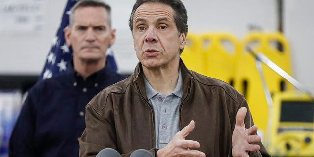 New York Gov. Andrew Cuomo speaks during a news conference alongside the National Guard at the Jacob Javits Center that will house a temporary hospital in response to the COVID-19 outbreak in March. (AP Photo/John Minchillo)