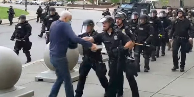 In this image from video provided  WBFO, a Buffalo police officer appears to shove a man who walked up to police Thursday, June 4, 2020, in Buffalo, N.Y. (Associated Press)