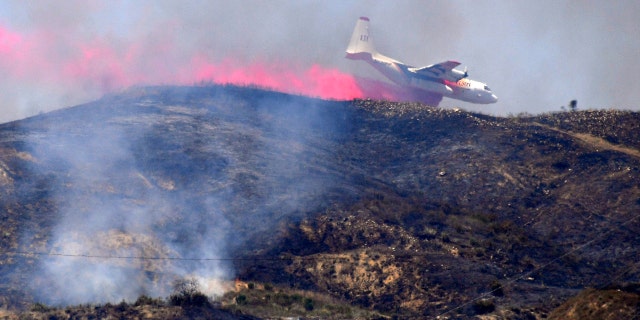 A firefighting aircraft drops fire retardant on the Elizabeth Fire, June 10, near Santa Paula, Calif.