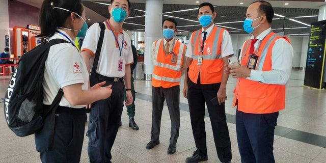 Members of a Chinese medical team are seen arriving at the airport in Phnom Penh, Cambodia, in April, to help conduct inspections amid new coronavirus protocols.