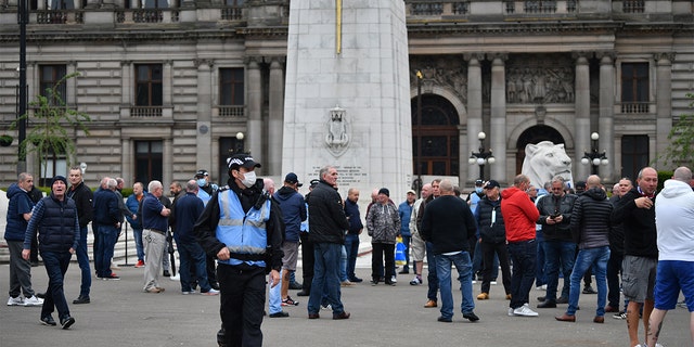 Activists gather at the cenotaph in George Square to protect it from any vandalism attacks on June 13, 2020 in Glasgow, Scotland. The Loyalist Defence League has asked followers to gather in George Square today for a 'protect the Cenotaph' event in response to statues being defaced across Scotland following BLM demonstrations.
