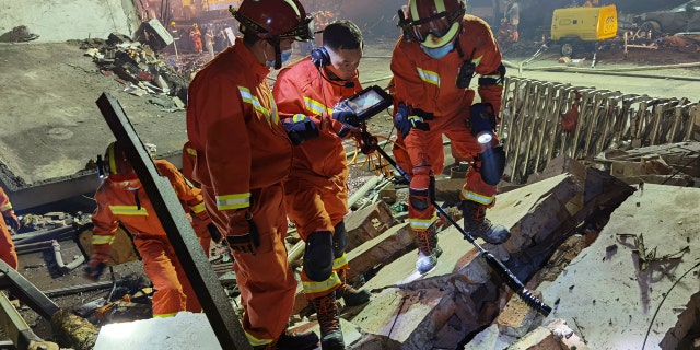 Firefighters look for residents trapped in collapsed buildings in the aftermath of a tanker truck explosion near a highway in Wenling in eastern China's Zhejiang province Saturday, June 13, 2020.