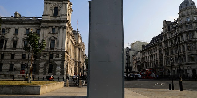 A protective covering installed overnight surrounds the statue of former British Prime Minister Sir Winston Churchill in Parliament Square, London, Friday, June 12, 2020, following Black Lives Matter protests that took place across the UK over the weekend. The protests were ignited by the death of George Floyd, who died after he was restrained by Minneapolis police on May 25. (Aaron Chown/PA via AP)