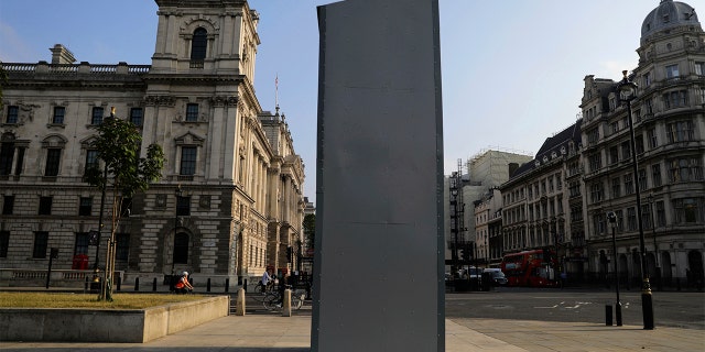 A protective covering installed overnight surrounds the statue of former British Prime Minister Sir Winston Churchill in Parliament Square, London, Friday, June 12, 2020, following Black Lives Matter protests that took place across the UK over the weekend. The protests were ignited by the death of George Floyd, who died after he was restrained by Minneapolis police on May 25. (Aaron Chown/PA via AP)