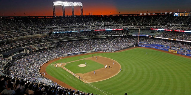 FILE - In this Aug. 29, 2019, file photo, the sun sets behind Citi Field during a baseball game between the New York Mets and the Chicago Cubs in New York. Major League Baseball players ignored claims by clubs that they need to take additional pay cuts, instead proposing they receive a far higher percentage of salaries and a commit to a longer schedule as part of a counteroffer to start the coronavirus-delayed season. (WHD Photo/Kathy Willens, File)