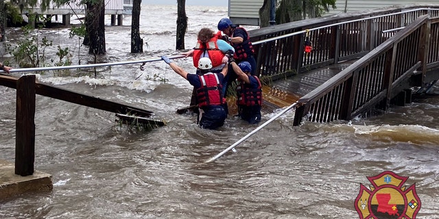 A rescue on Monday in Mandeville, La. after storm surge flooding from Tropical Depression Cristobal.